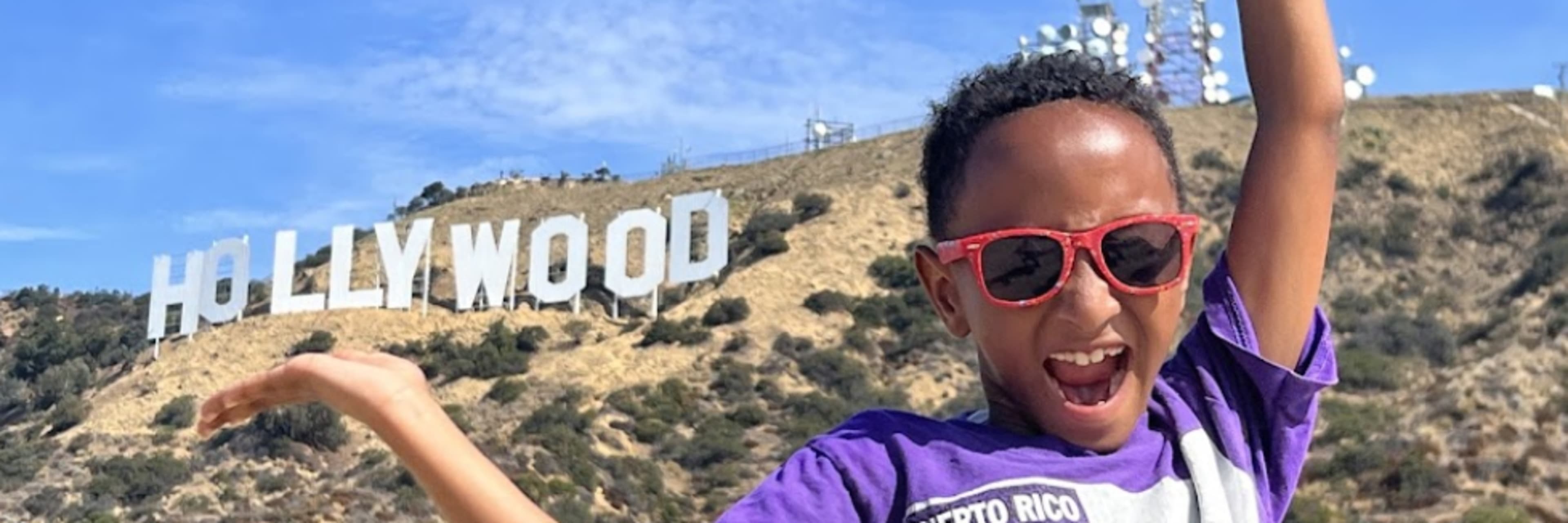 man pointing to hollywood sign