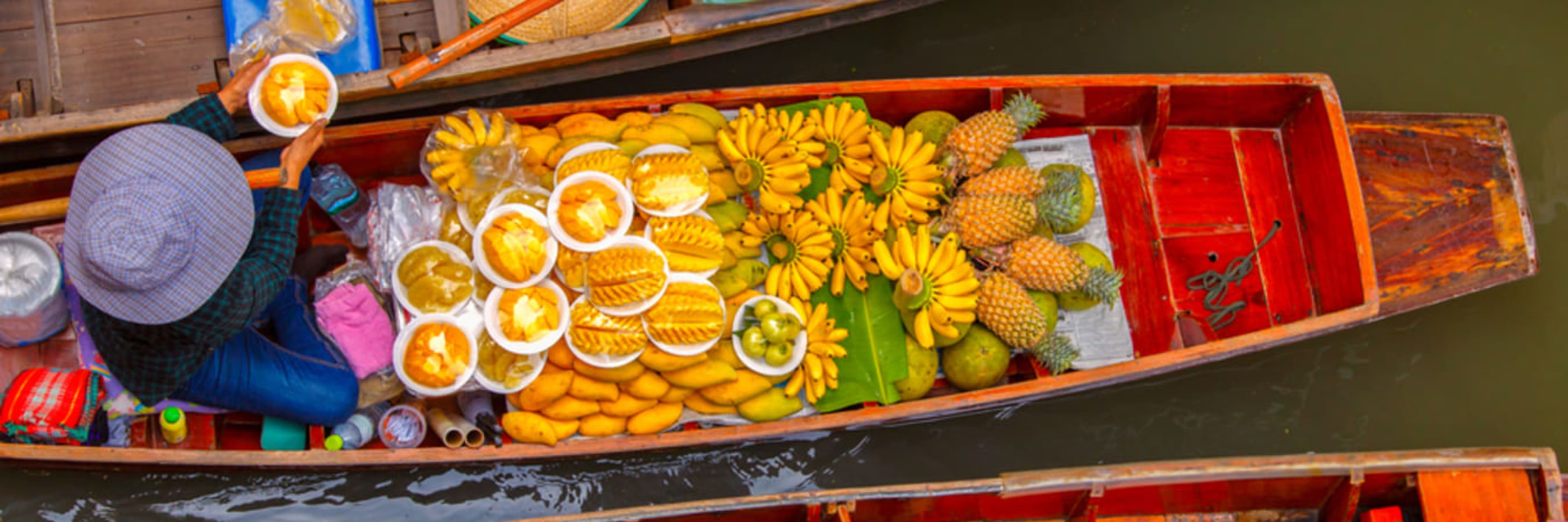 Fruit seller at Damnoen Saduak floating market near Bangkok.