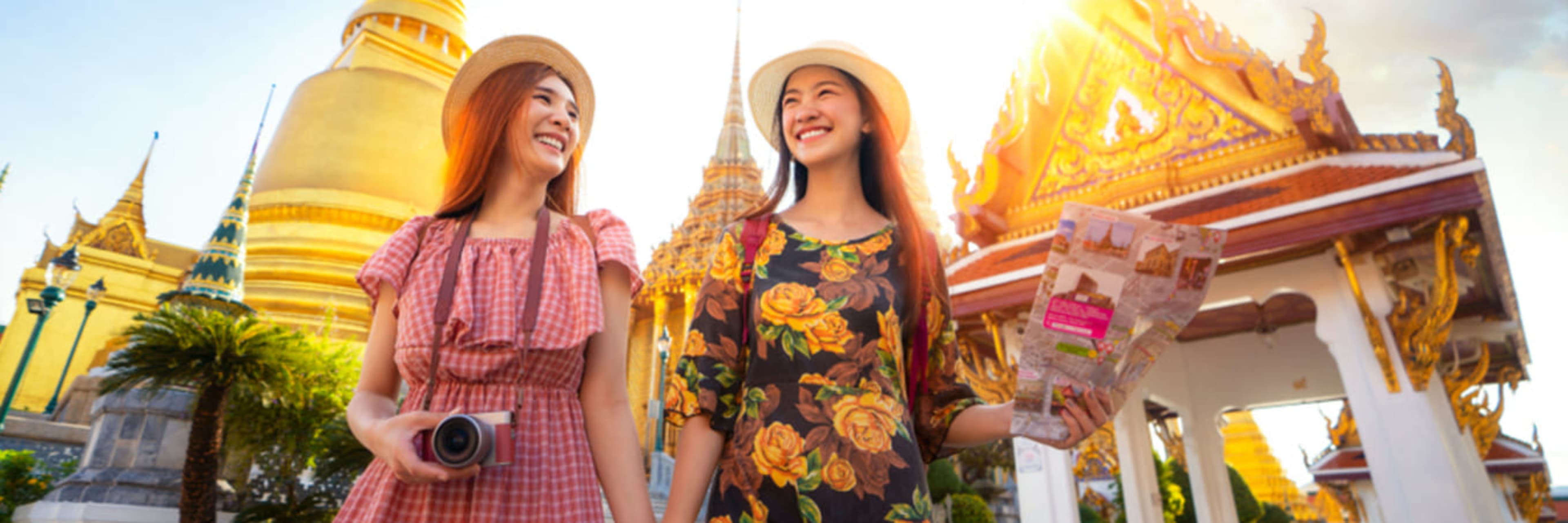 Two women exploring the Grand Palace complex in Bangkok.