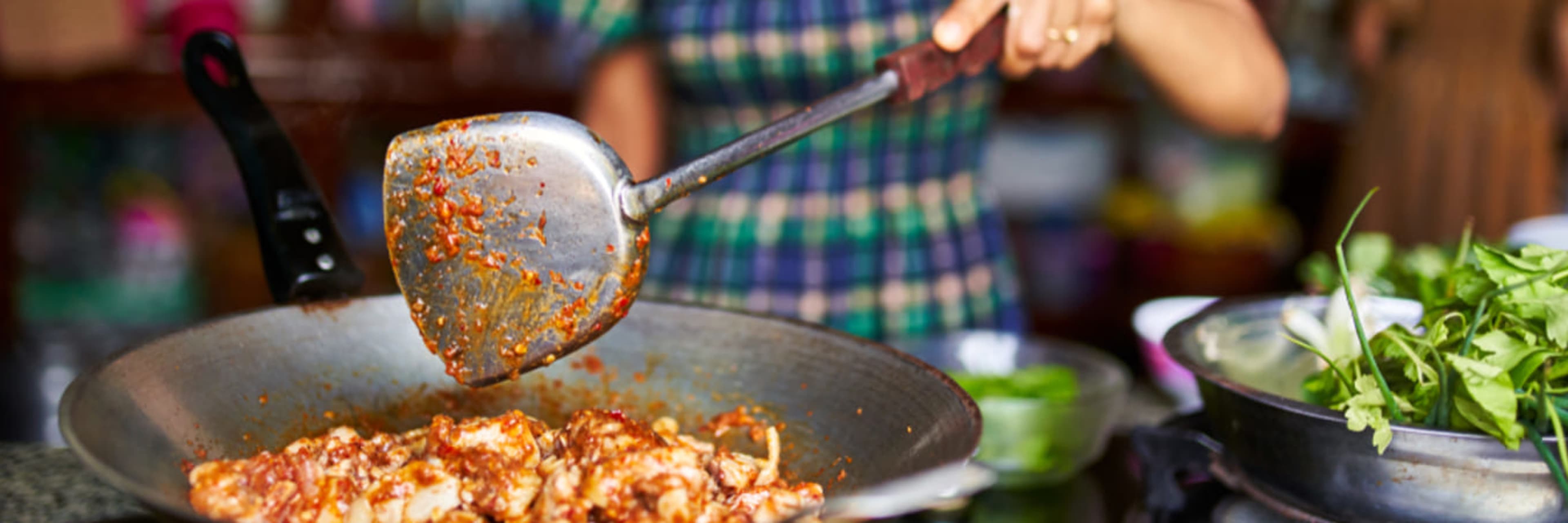 Woman cooking Thai food.