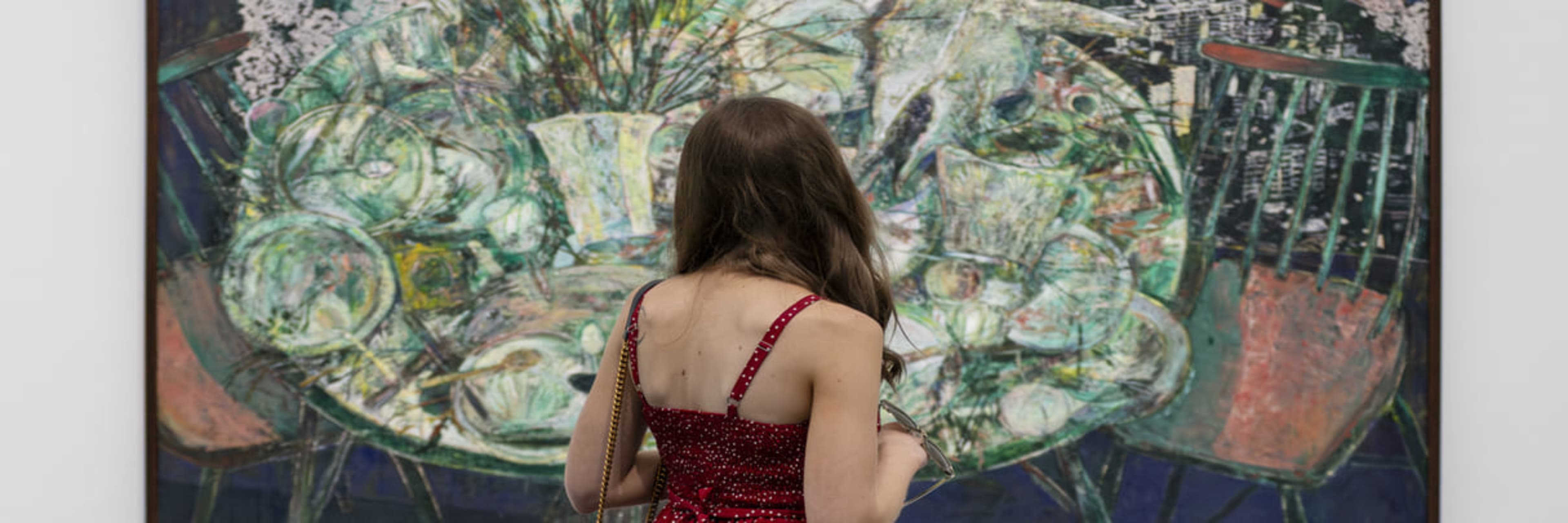 Woman looking at painting