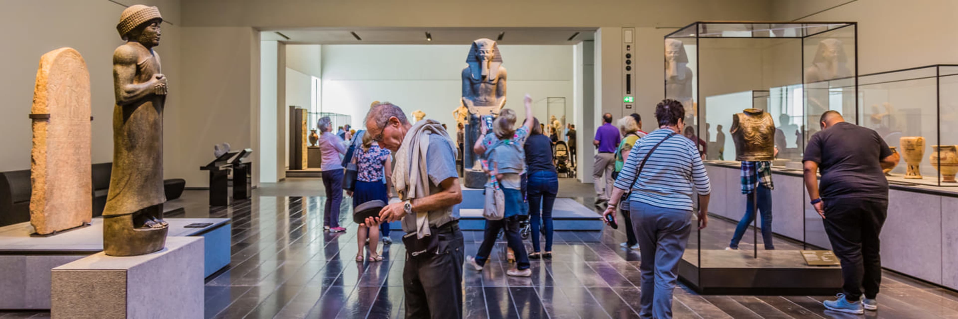 Tourists examining exhibits at the Louvre Abu Dhabi museum.