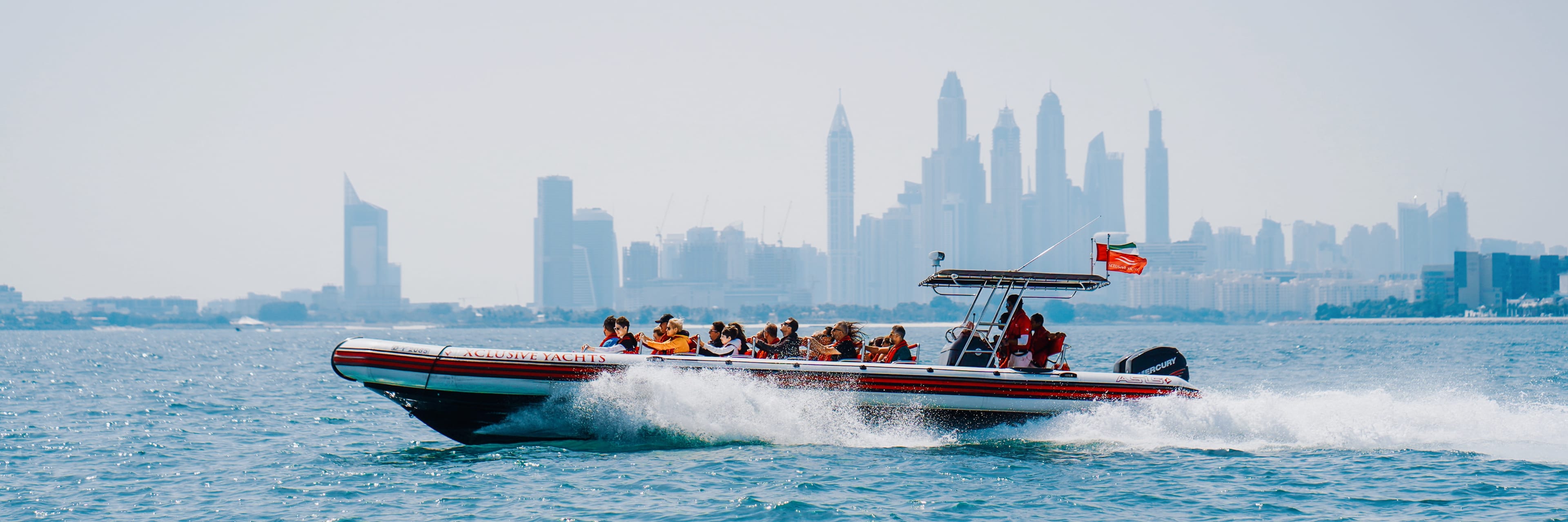 Speedboat cruising against the Dubai skyline.