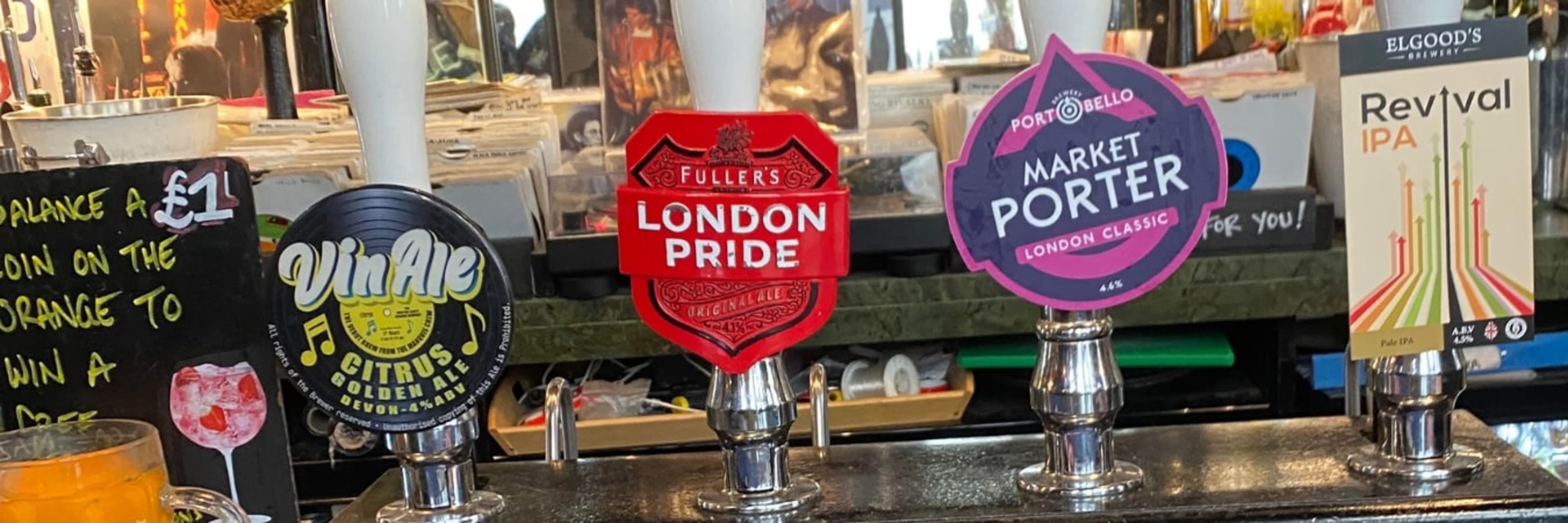 Ale pumps along a bar in a London pub.