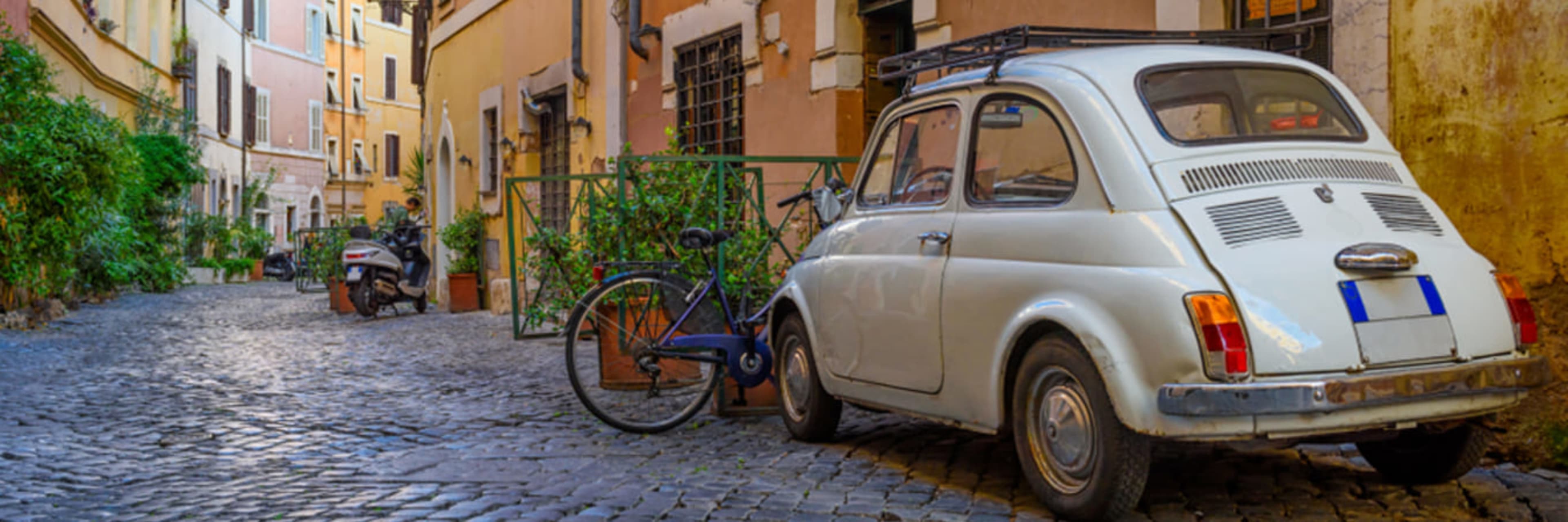 Old-fashioned Italian car in a cobbled Trastevere lane.