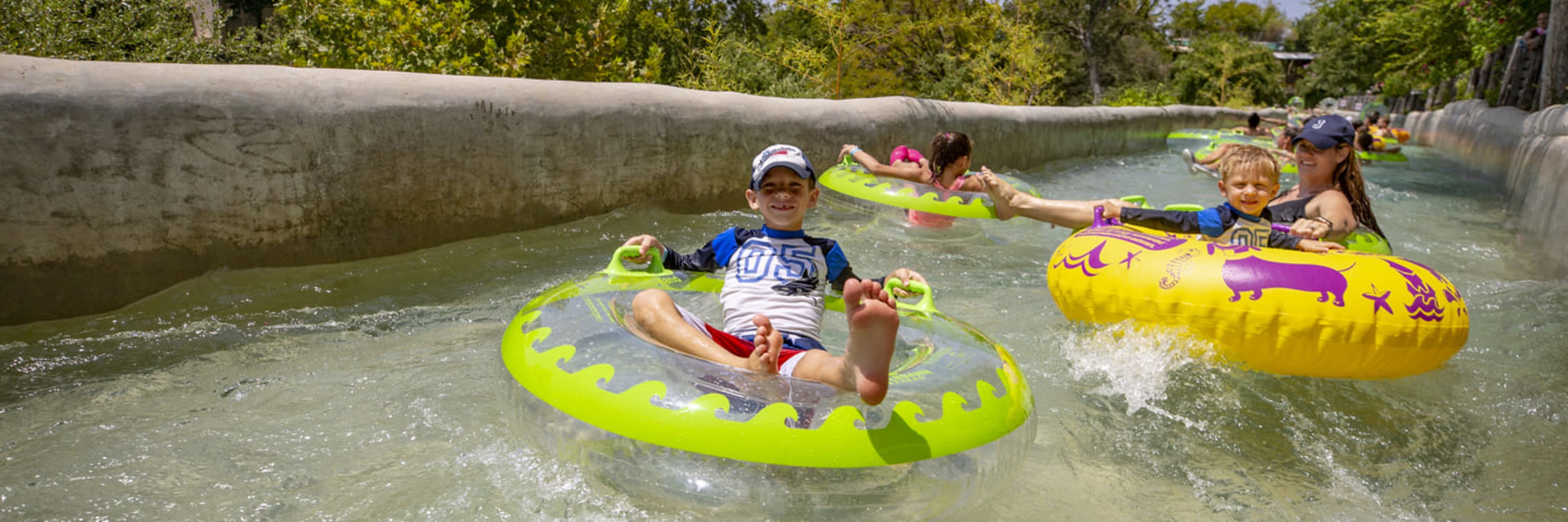 Family on a lazy river at Shlitterbahn Waterpark in New Braunfels, Texas.