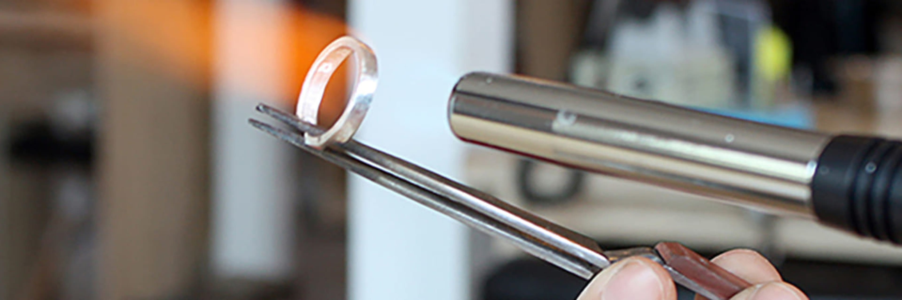 Ring-maker applying heat to a silver ring