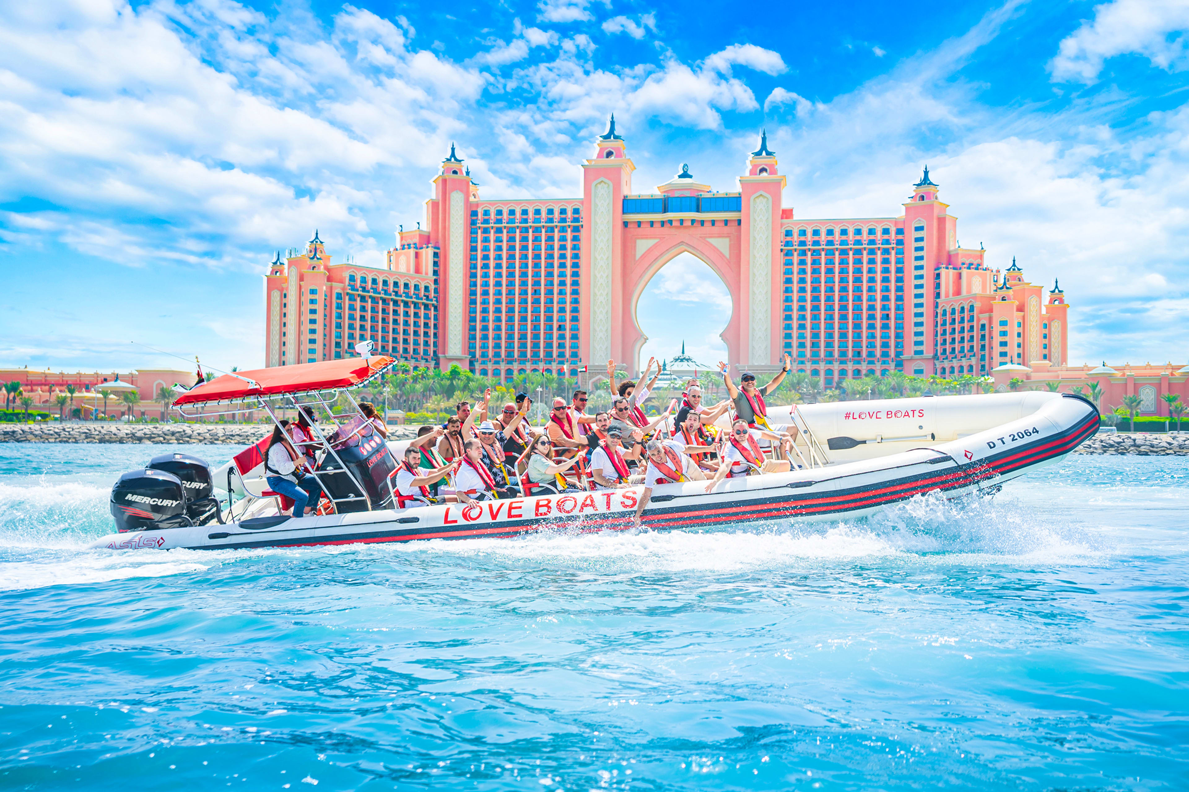 Speedboat cruising against the Dubai skyline.