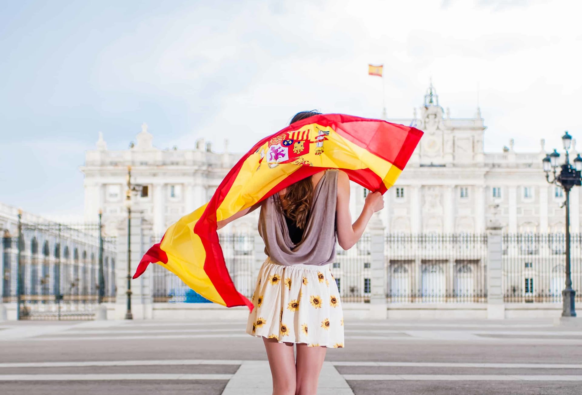 Woman in Madrid holding a Spanish flag