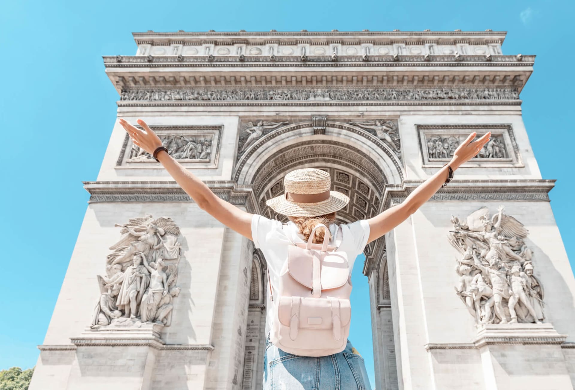 A tourist admires the Arc du Triomphe