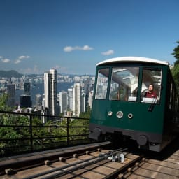 The Peak Tram funicular set against the Hong Kong city skyline.
