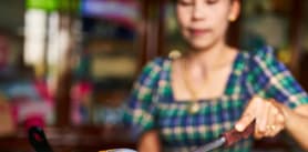 Woman cooking Thai food.