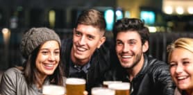 Group of people enjoying drinks in a pub.