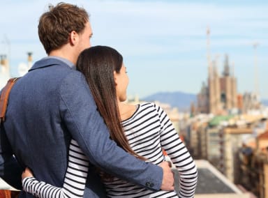 Couple overlooking Barcelona from a rooftop