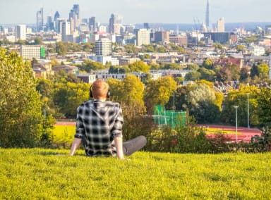 Man sitting on Parliament Hill in Hampstead Heath