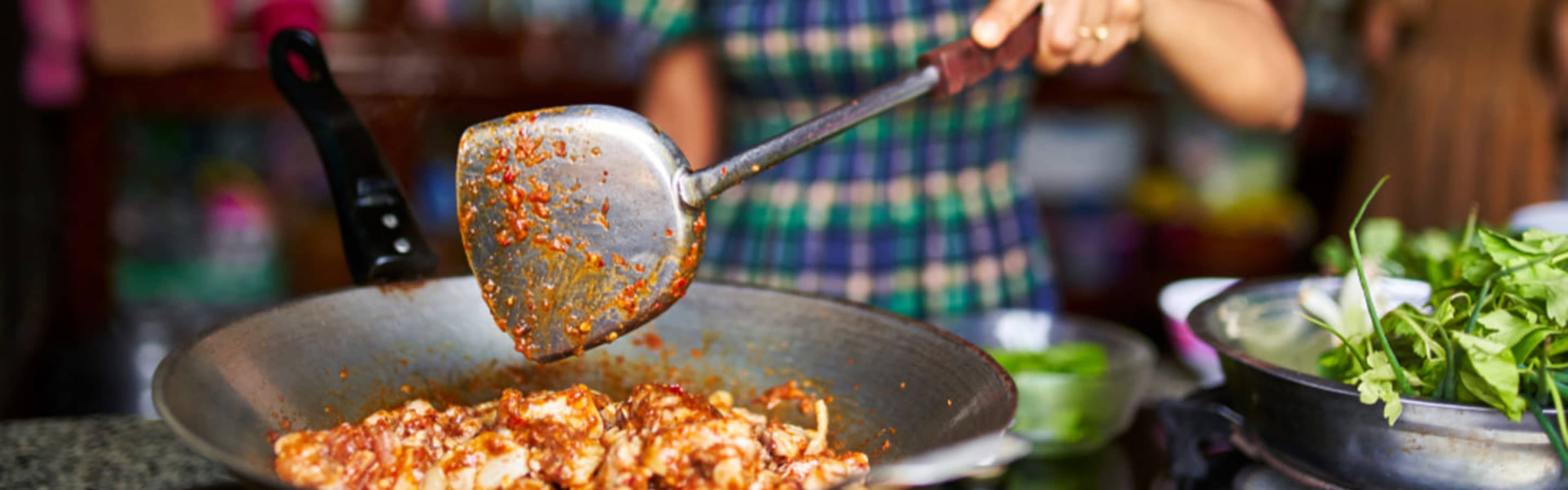 Woman cooking Thai food.