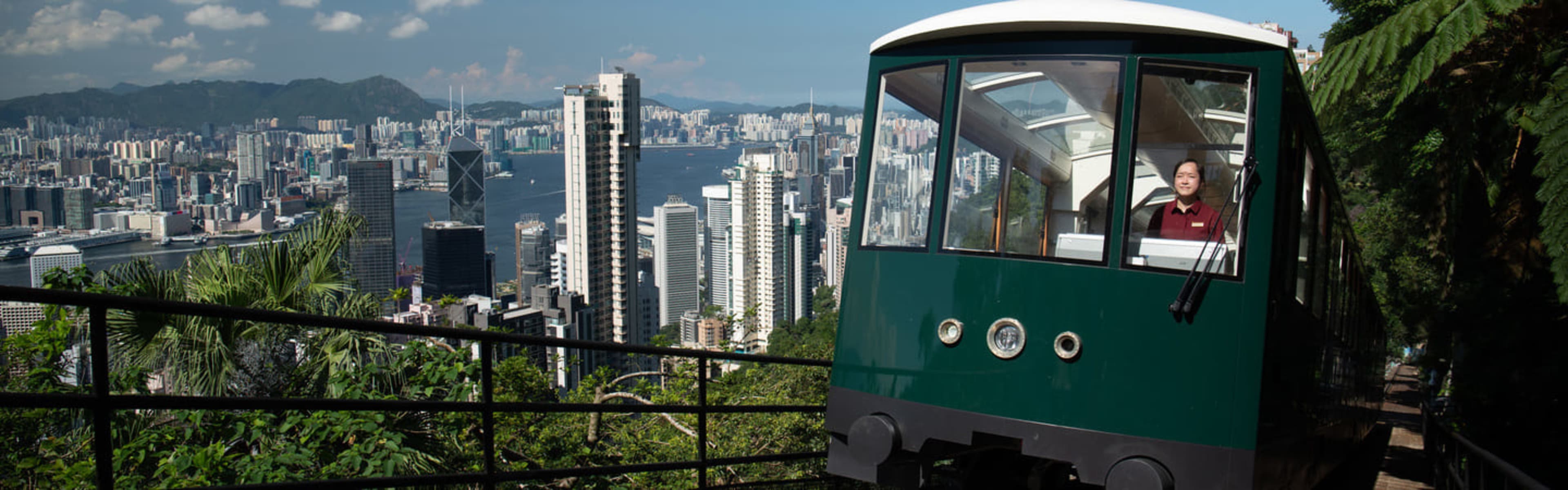 The Peak Tram funicular set against the Hong Kong city skyline.