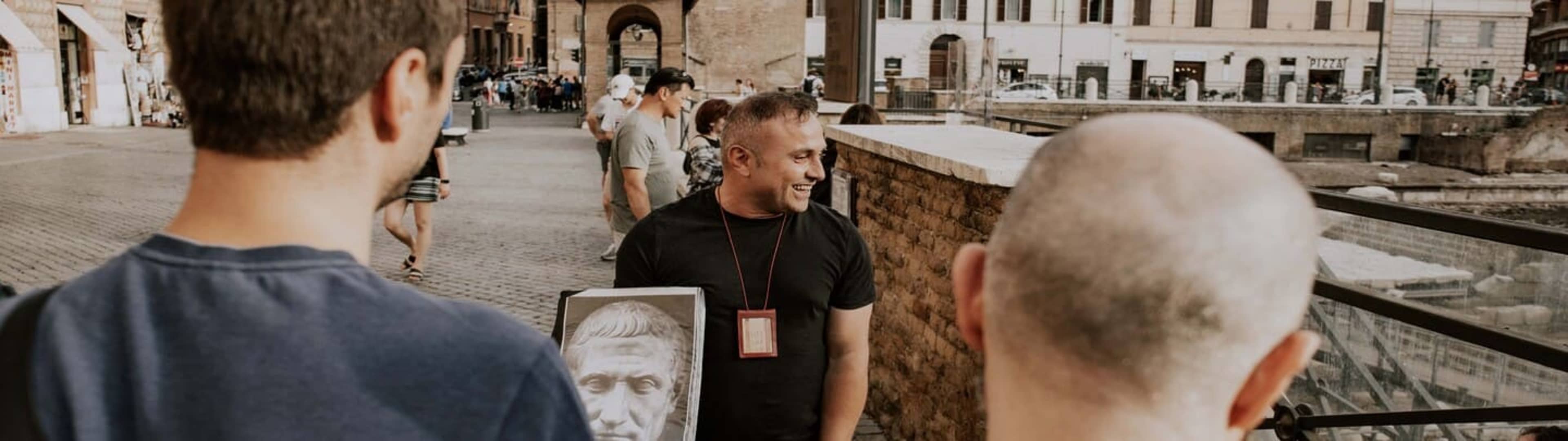 people looking at man holding portrait