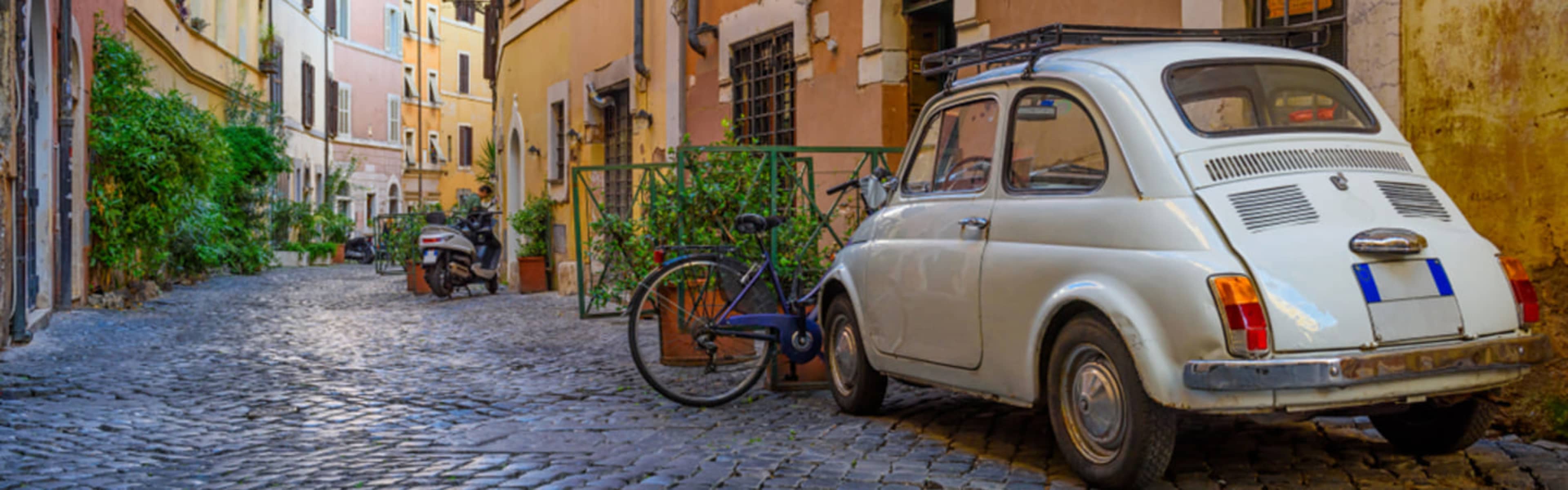 Old-fashioned Italian car in a cobbled Trastevere lane.