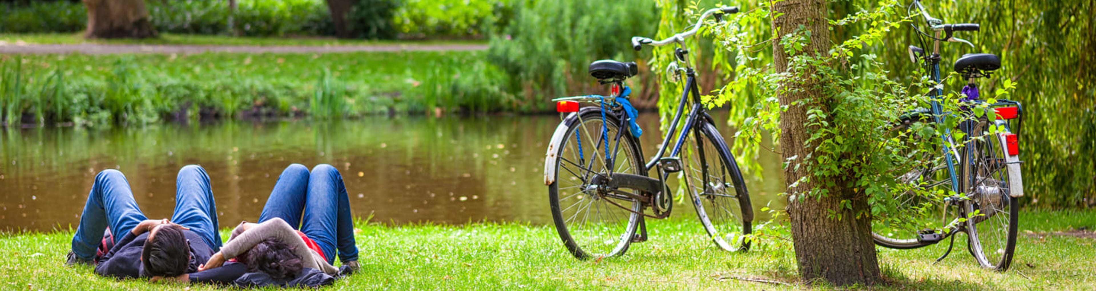 Cyclists taking a break on the grass in Amsterdam's Vondelpark