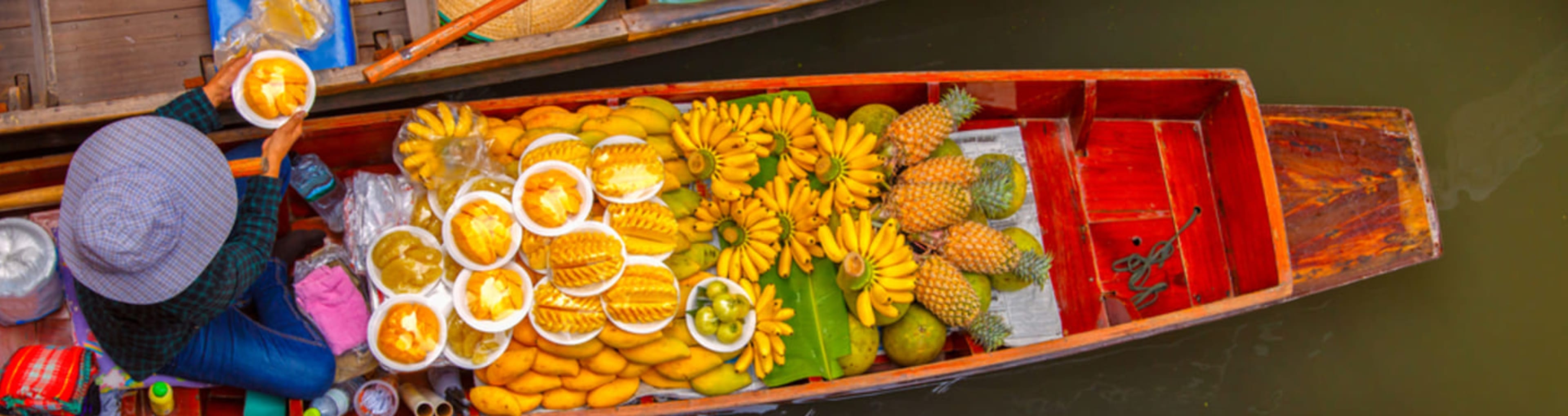 Fruit seller at Damnoen Saduak floating market near Bangkok.