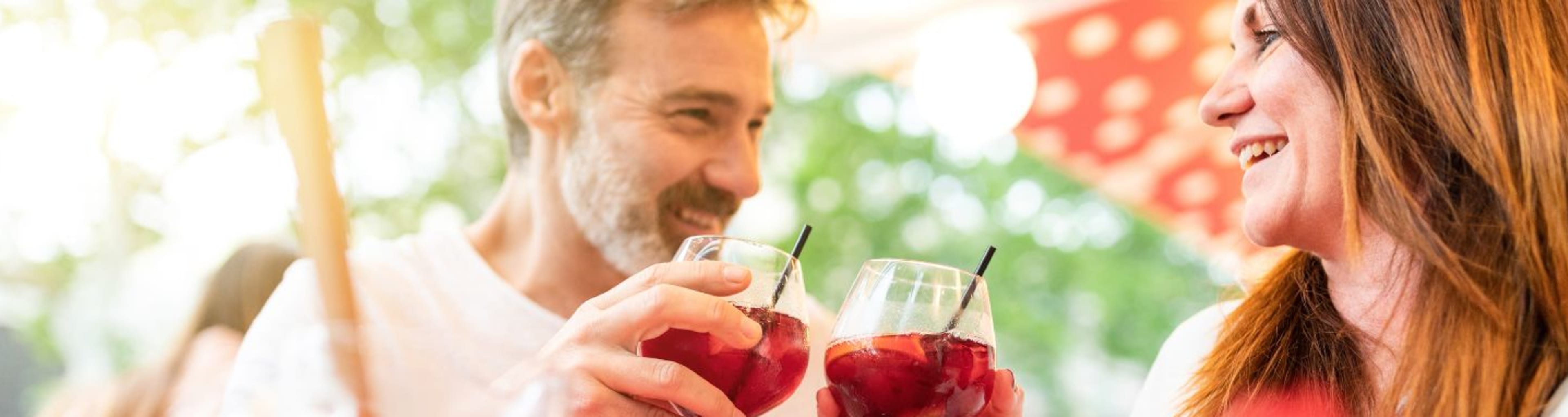 Cropped shot of man and women sharing cocktails in the daytime