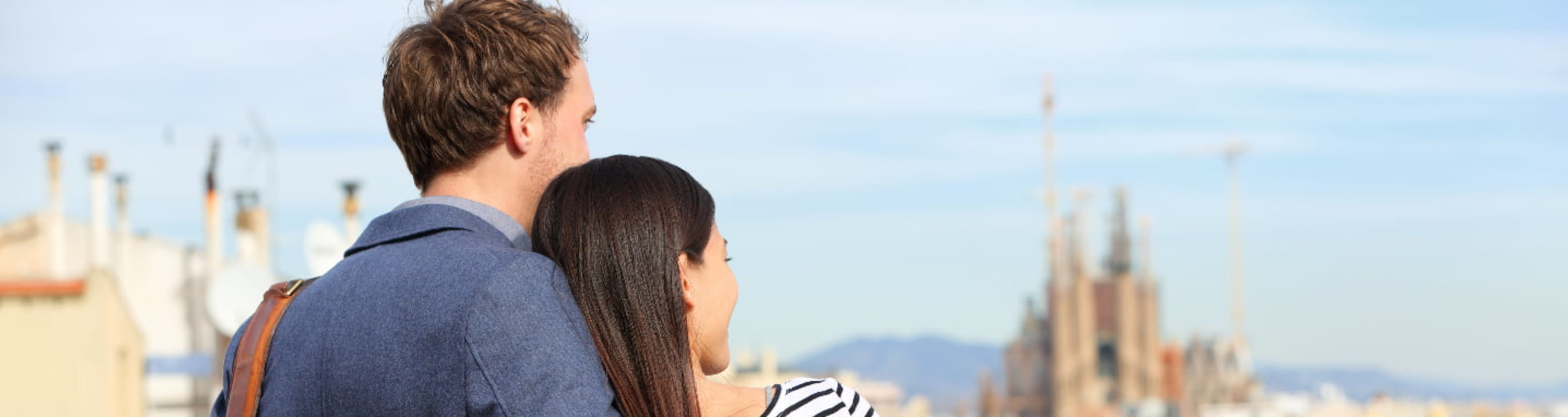 Couple overlooking Barcelona from a rooftop