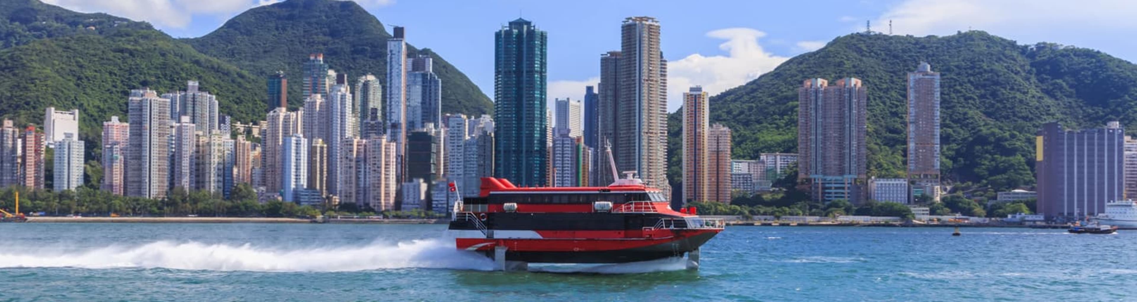 Sightseeing speedboat cruising past the Hong Kong city skyline