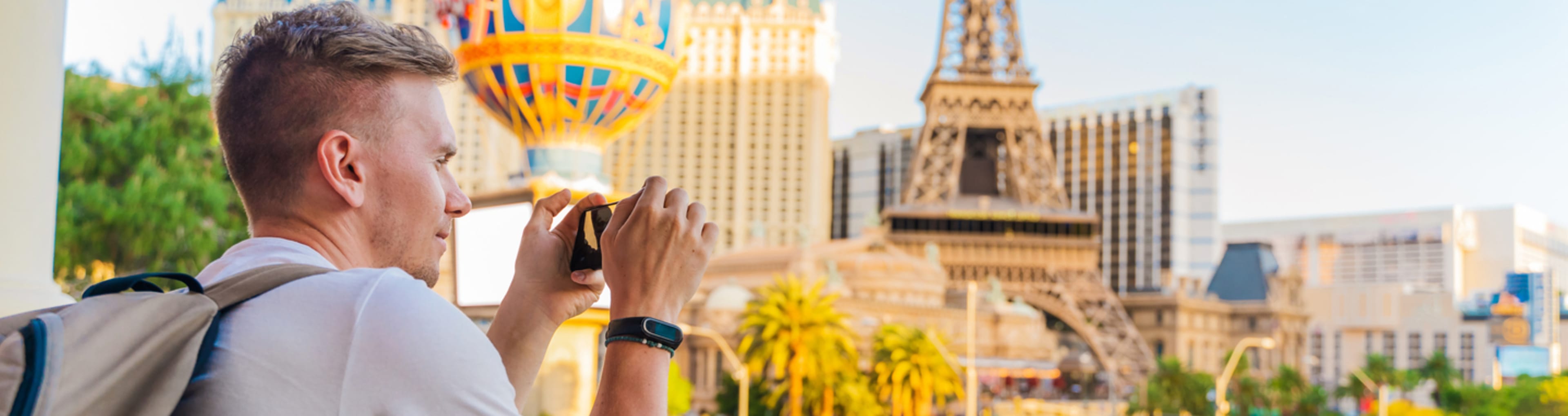 Tourist taking photo of the replica Eiffel Tower in Las Vegas