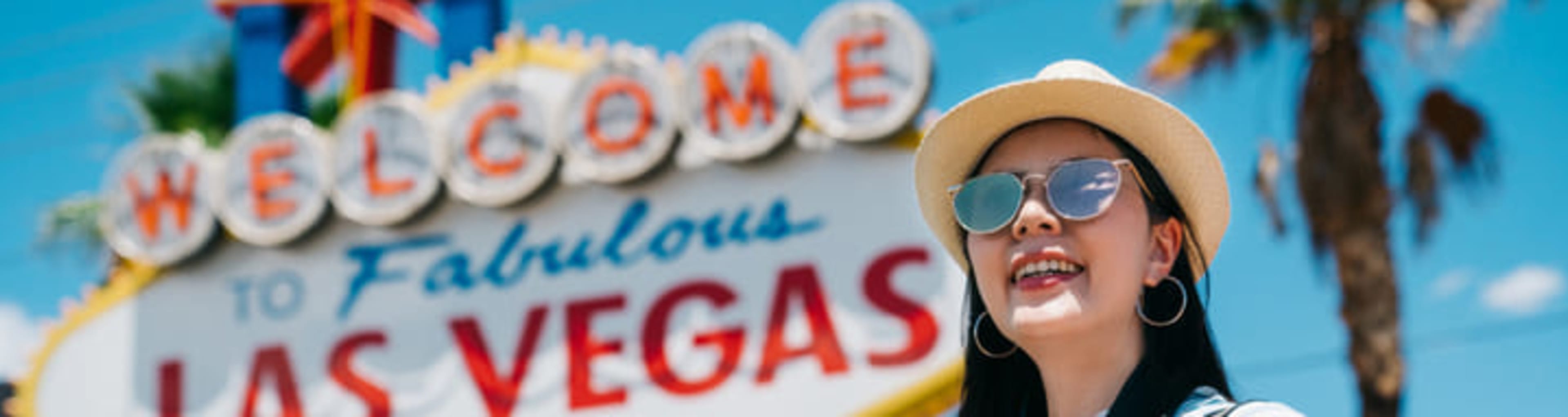 Woman taking photos at the iconic 'Welcome to Fabulous Las Vegas' sign