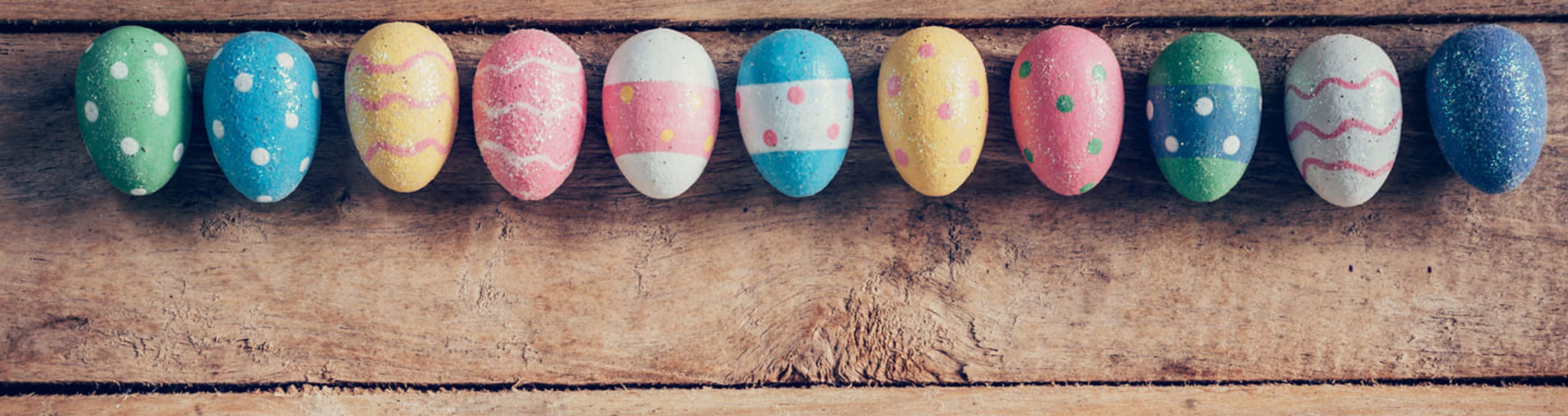 Colorfully painted Easter eggs on a wooden table