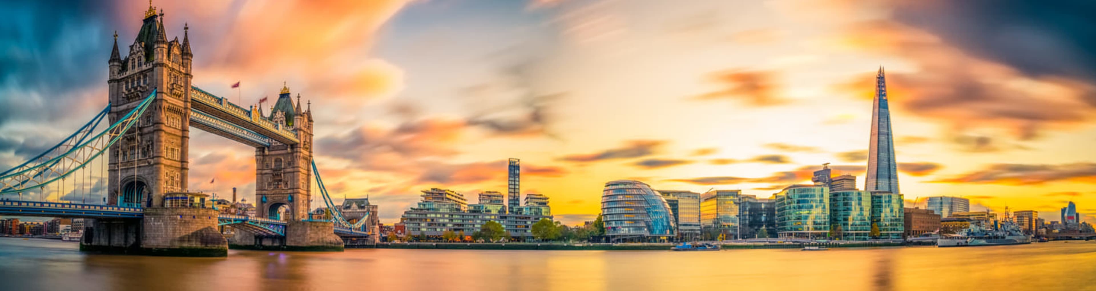 The London skyline at sunset, including Tower Bridge and The Shard