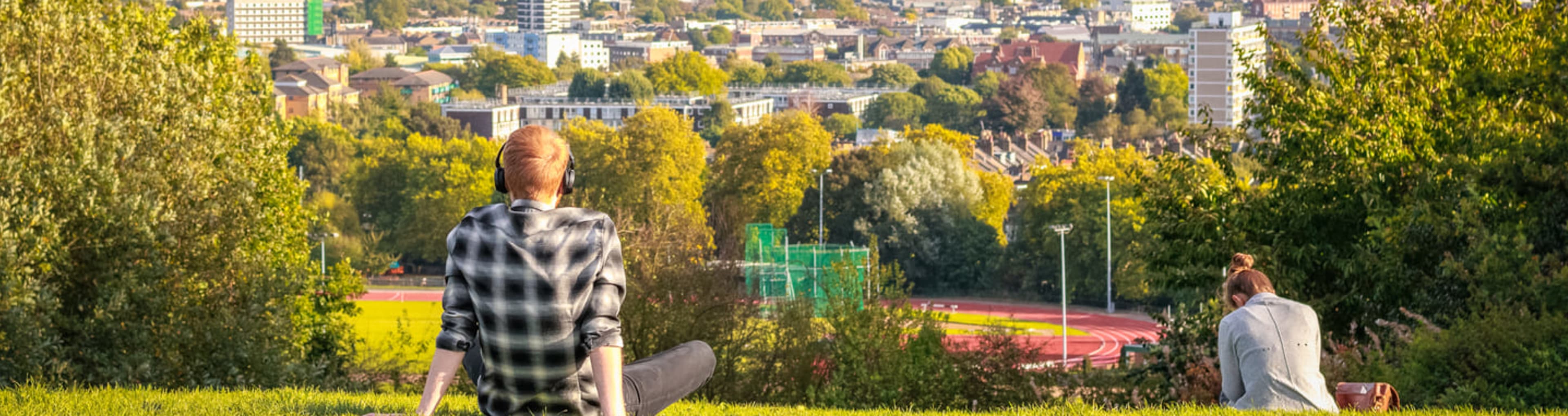 People sitting on Parliament Hill in Hampstead Heath