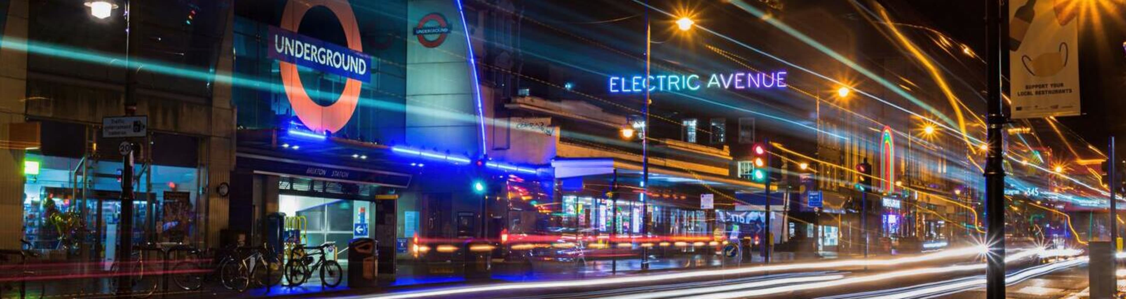 Brixton underground station and Electric Avenue at night.