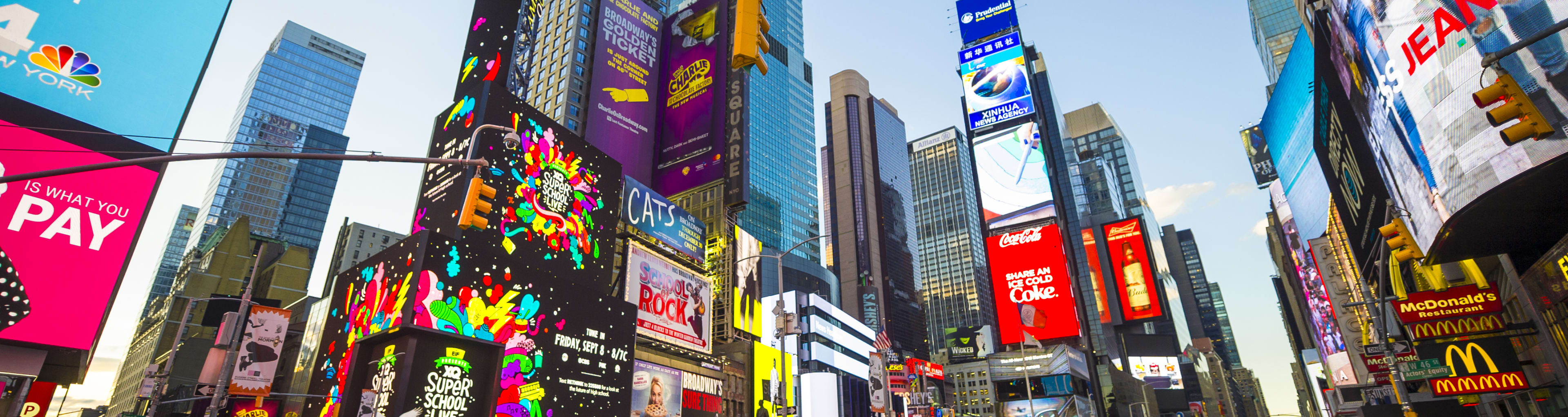 Street view of Times Square neon signs and NYC yellow taxi