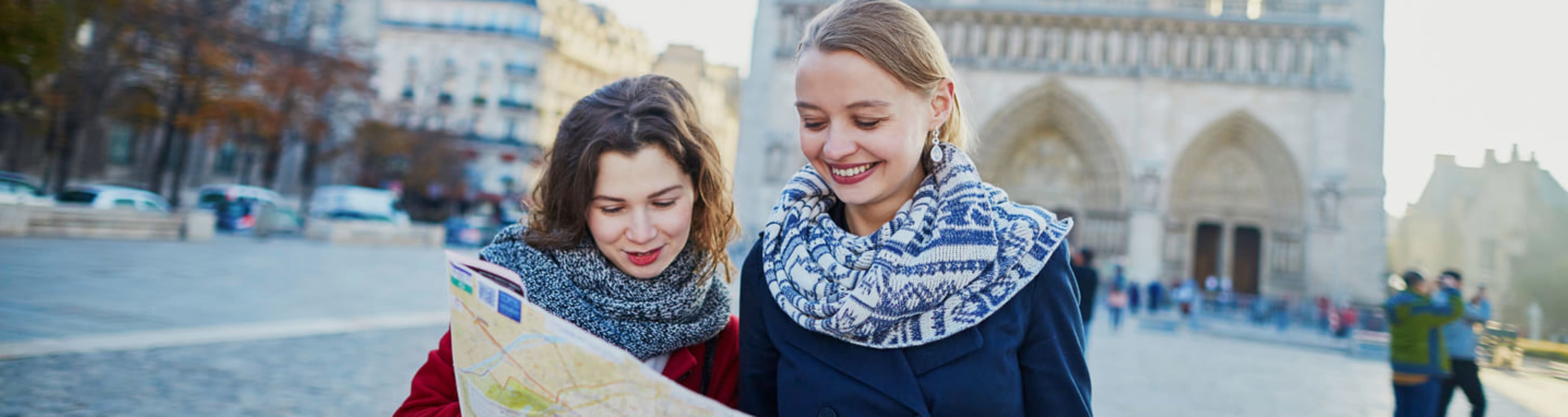 Women consulting a map by Notre-Dame Cathedral in Paris