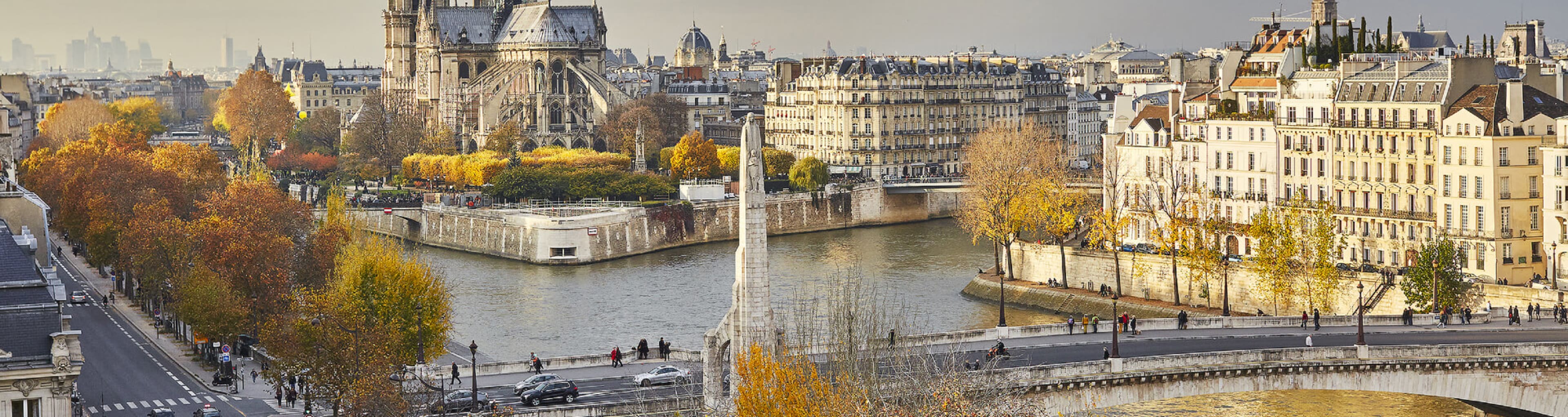 A panoramic view of Paris focused on Notre Dame Cathedral in fall