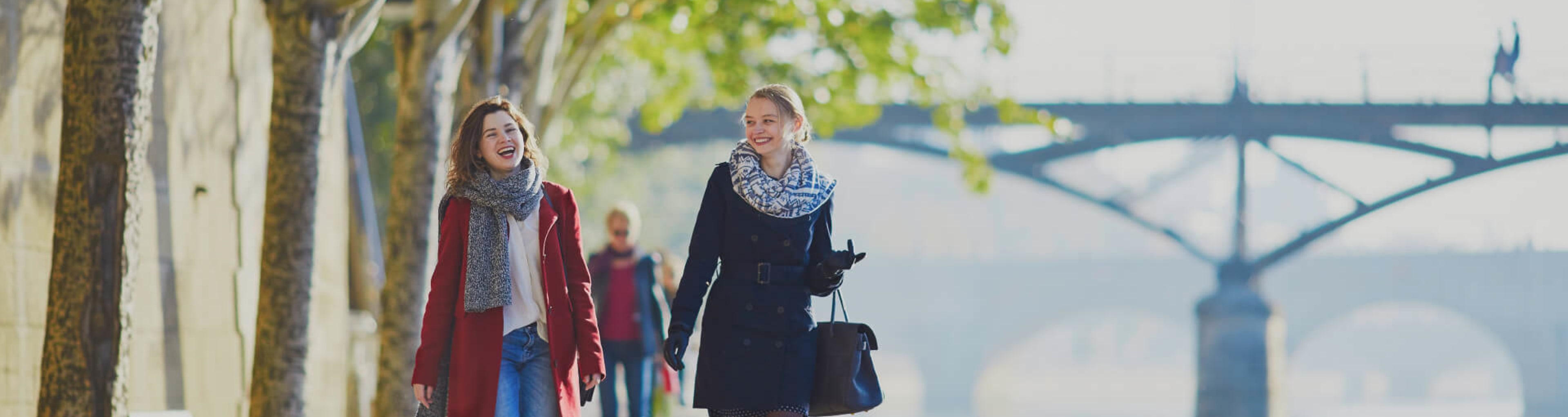 Two women enjoy a walk along the banks of the Seine