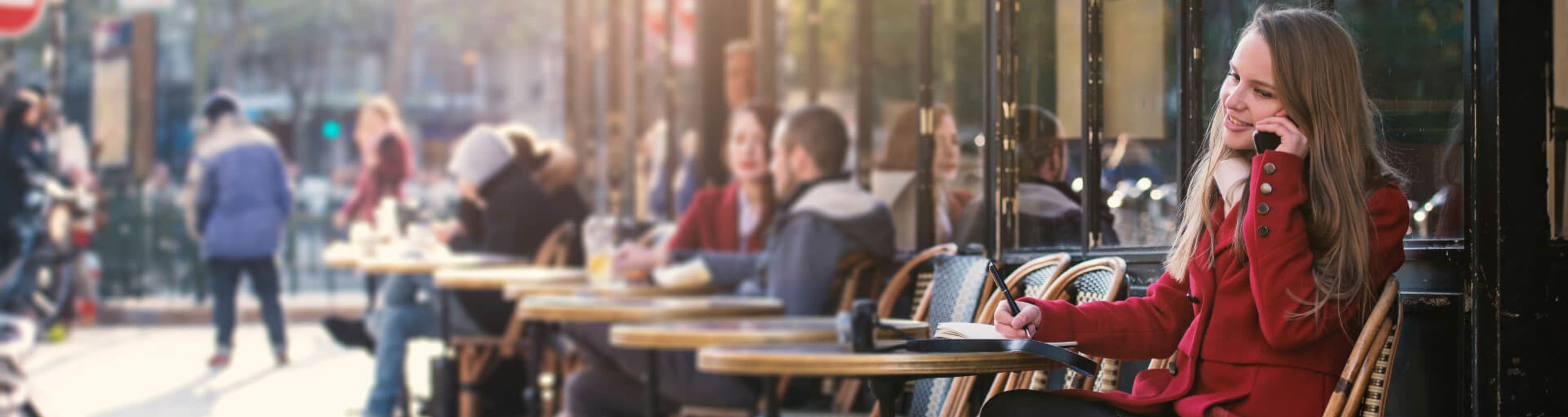 Parisians sitting at exterior cafe tables