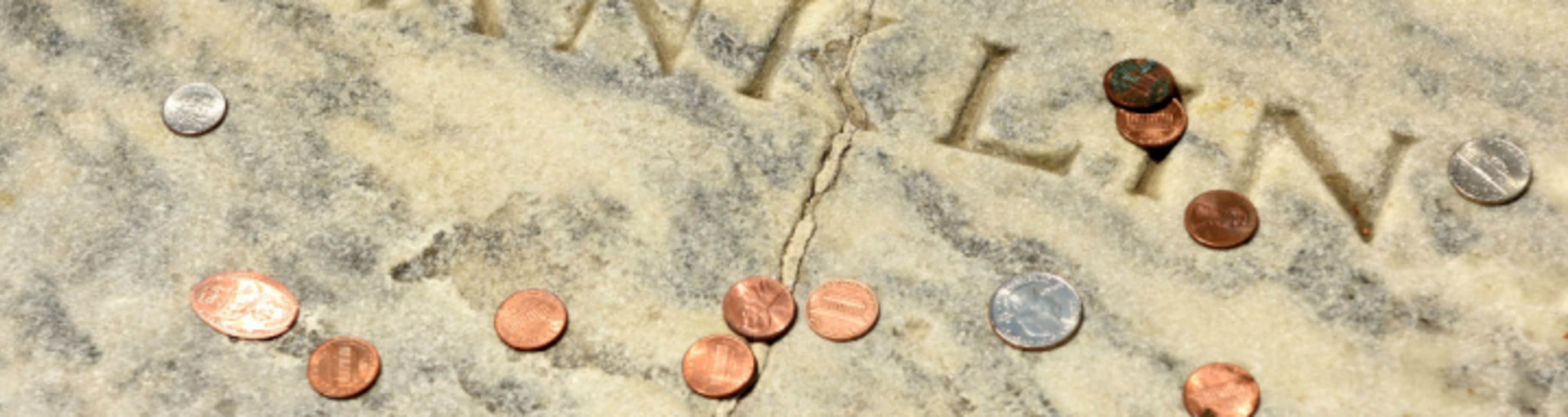 Benjamin Franklin's grave covered in pennies, one of the best outdoor activities in Philadelphia 