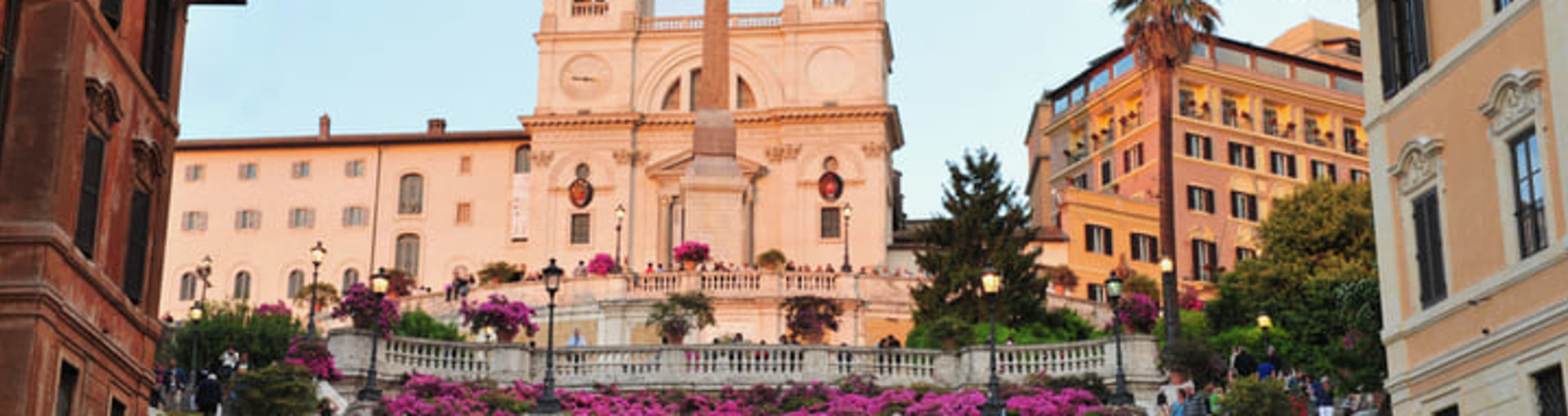 Couple descending the Spanish Steps in Rome, with the Trinità dei Monti church behind them