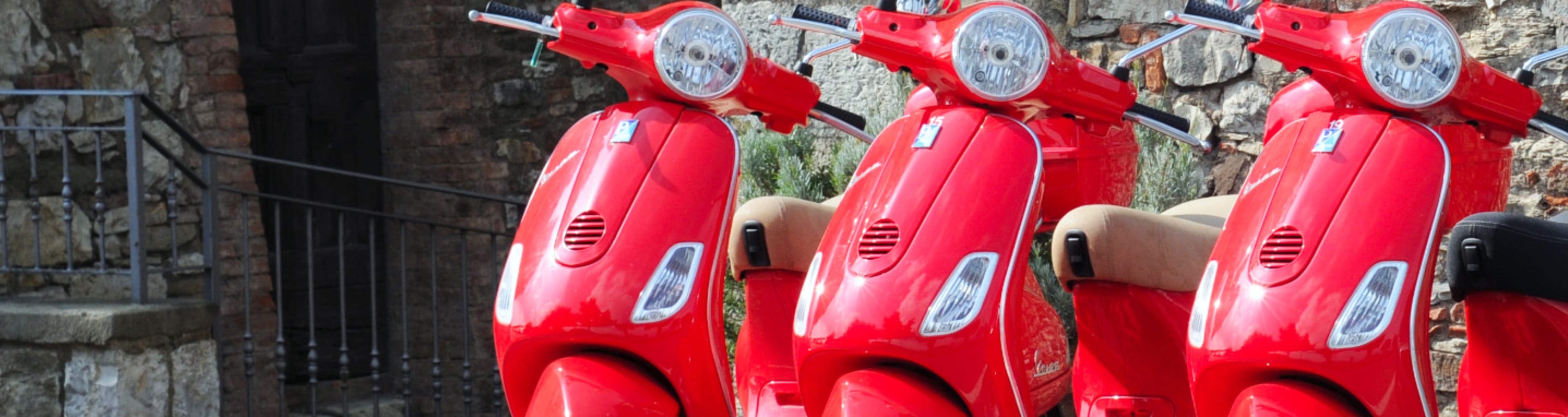 Red Vespas parked in a line