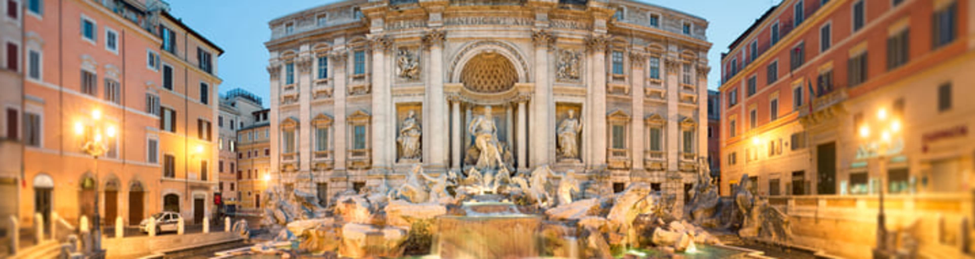 The Trevi Fountain in Rome, illuminated at dusk