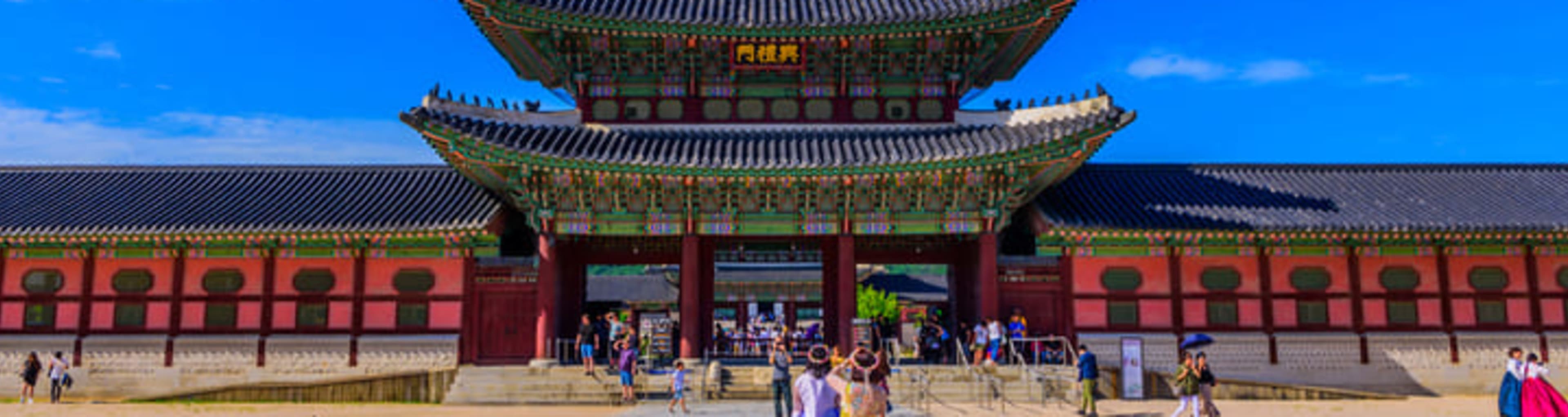 Koreans in traditional dress at the entrance to Gyeongbokgung Palace in Seoul.