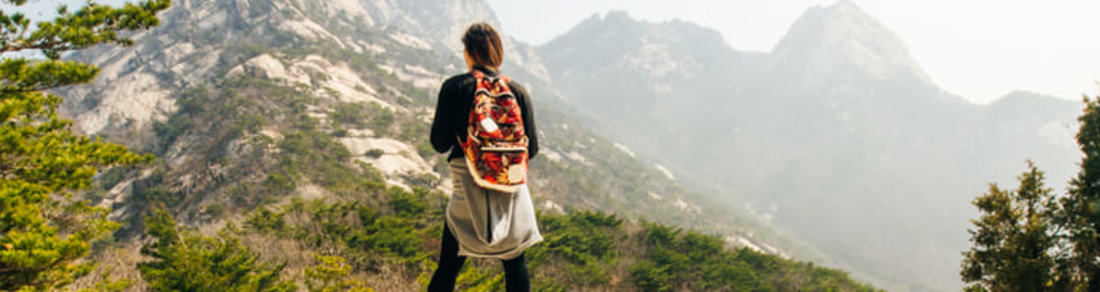 A hiker admiring the view in Bukhansan National Park, Seoul.