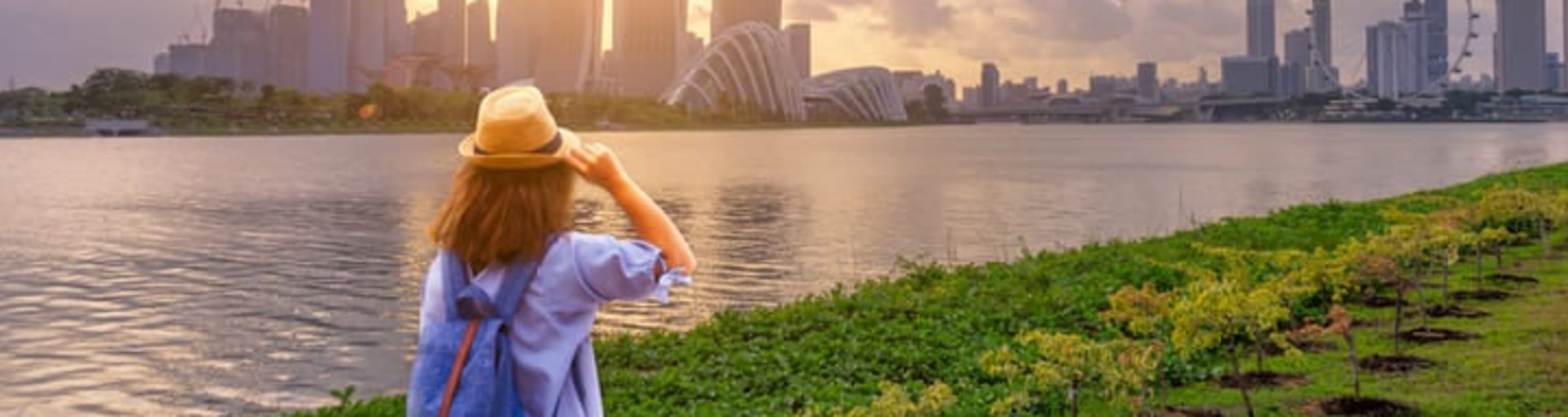 Woman watching the sun set over Marina Bay Sands in Singapore.