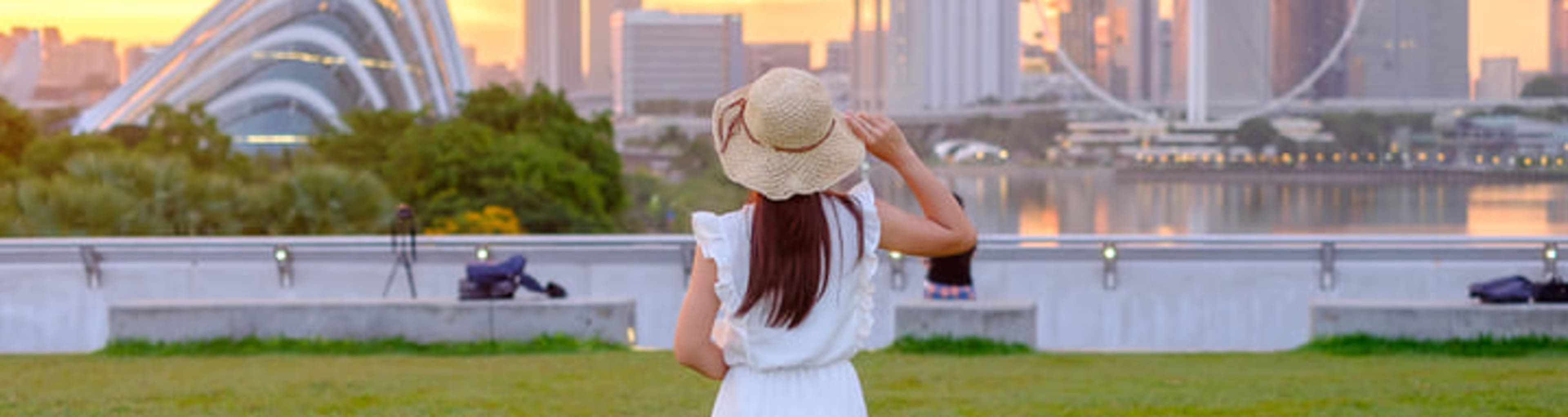 Woman looking across the water to the Singapore Flyer