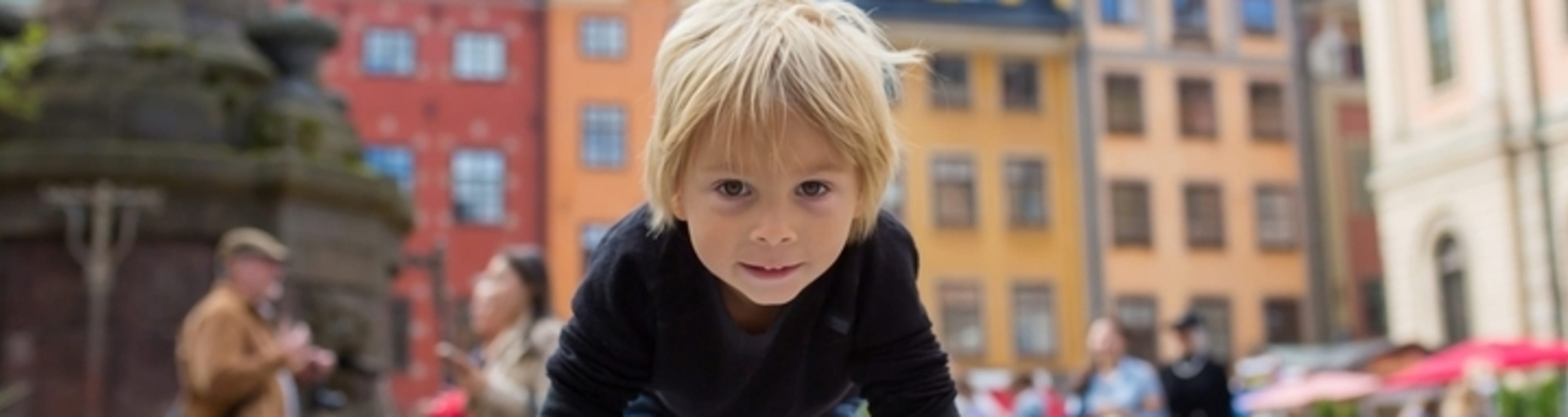 Little boy exploring Stortorget square in Stockholm's old town