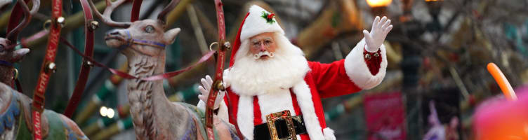 Santa Claus waving at the Chicago Christmas light switch on