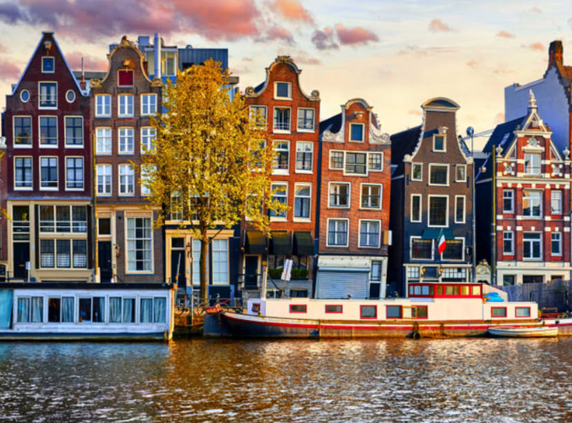 Colorful canal houses lining an Amsterdam canal